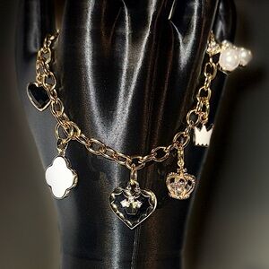 Elegant Gold Charm Bracelet with Black and White Accents